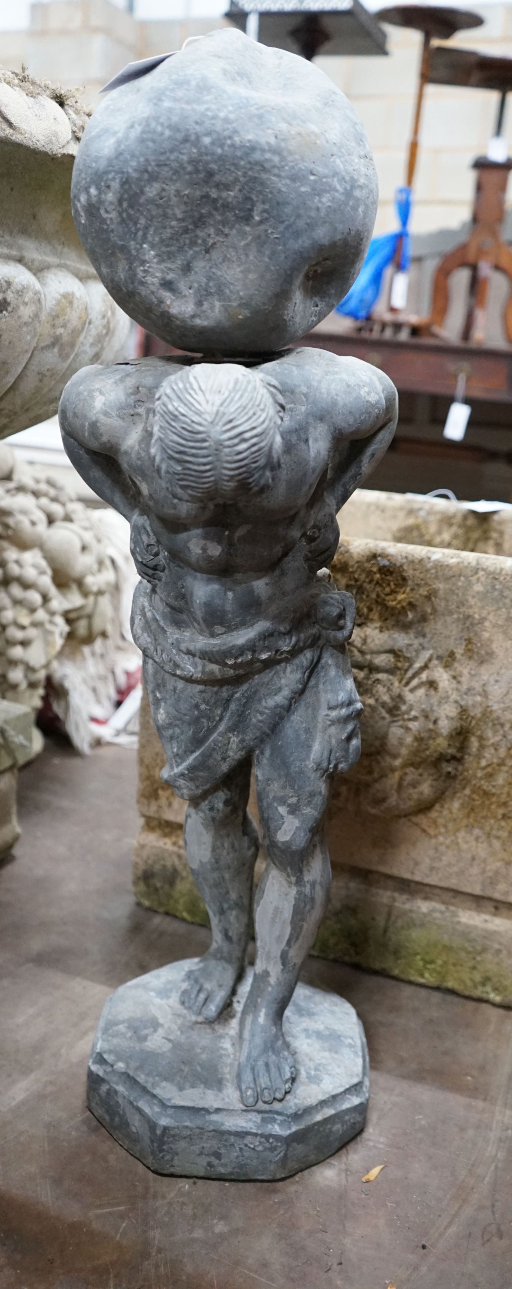 A small weathered lead garden ornament of Atlas, height 74cm